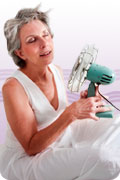 Hormones: photo of menopausal woman holding a fan during hot flash.